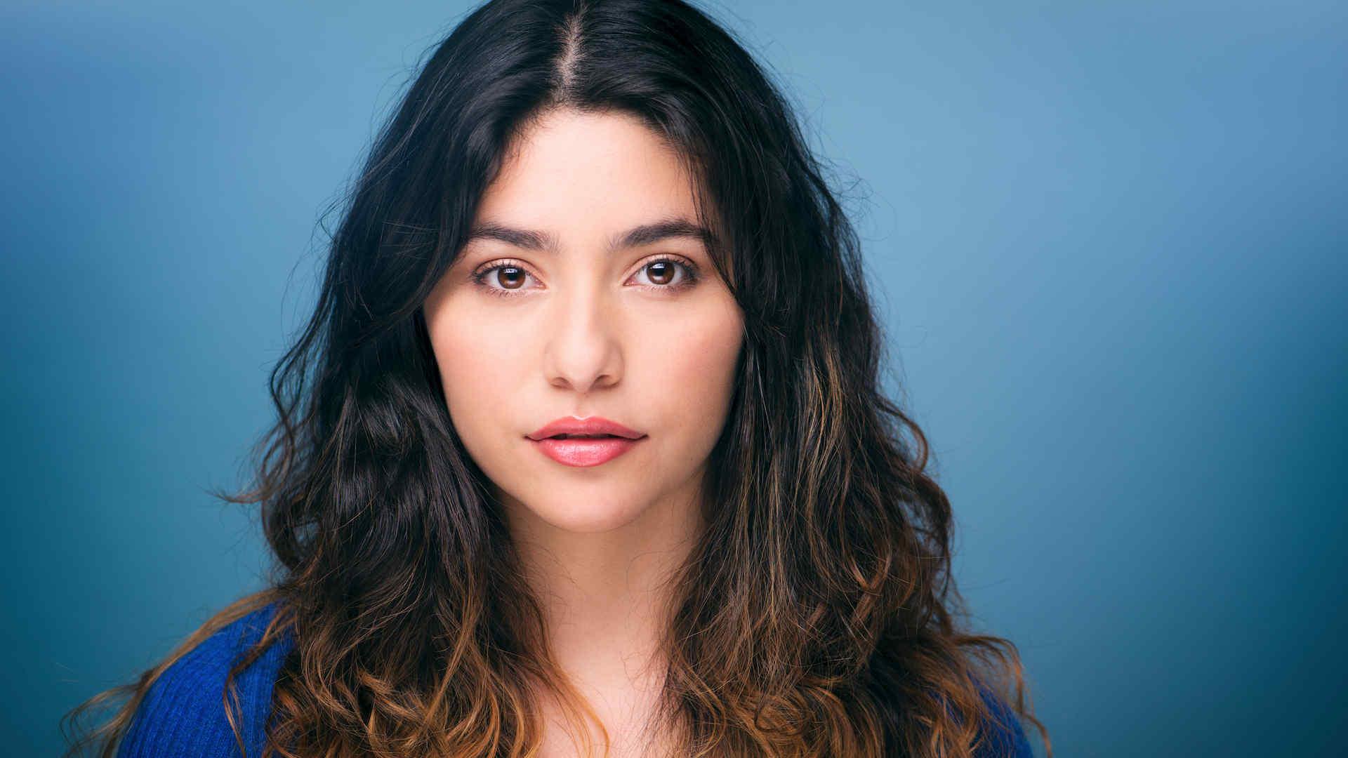 Headshot of Gabriela Torres against a blue background